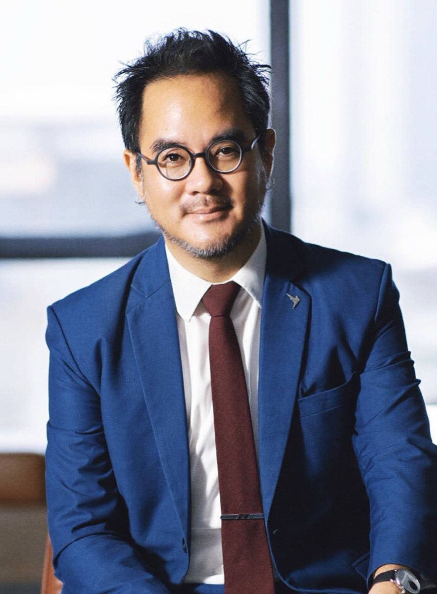 Dr Non Arkaraprasertkul in a blue suit